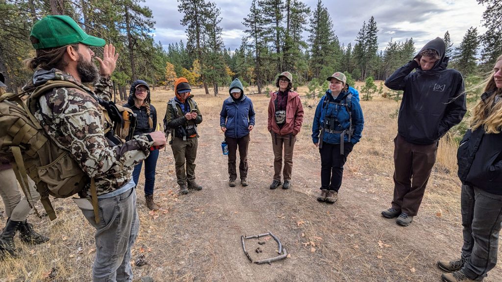 Photo of workers talking out in the field.