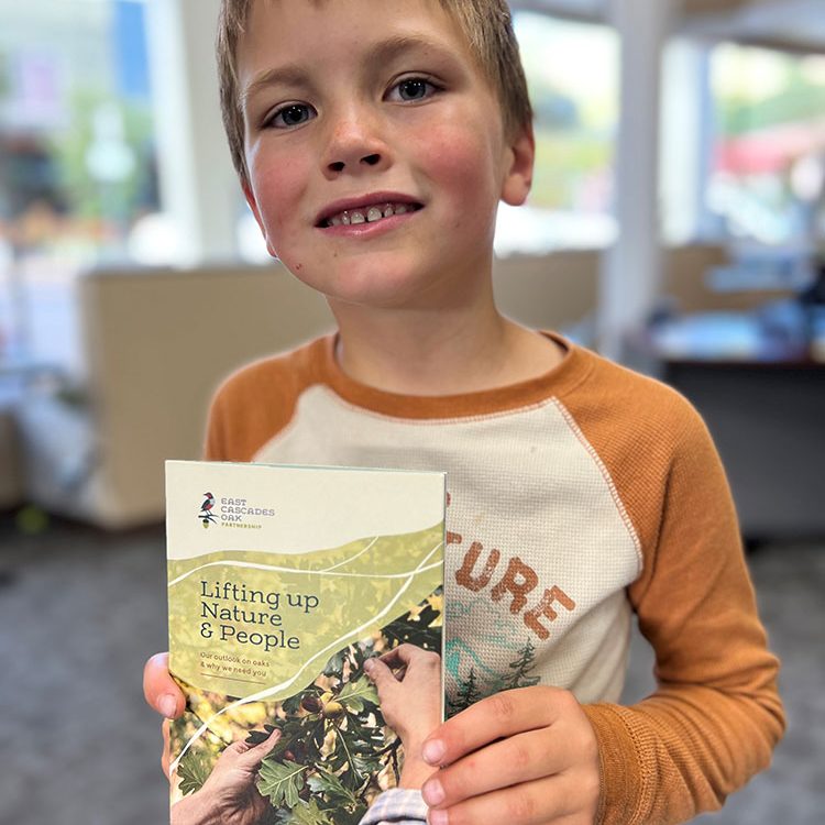 Photo of child holding ECOP brochure.